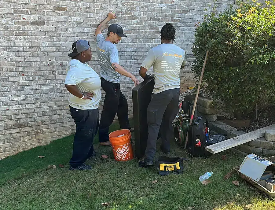 Xcalibur Services technicians conducting AC installation outside of home in Birmingham, AL