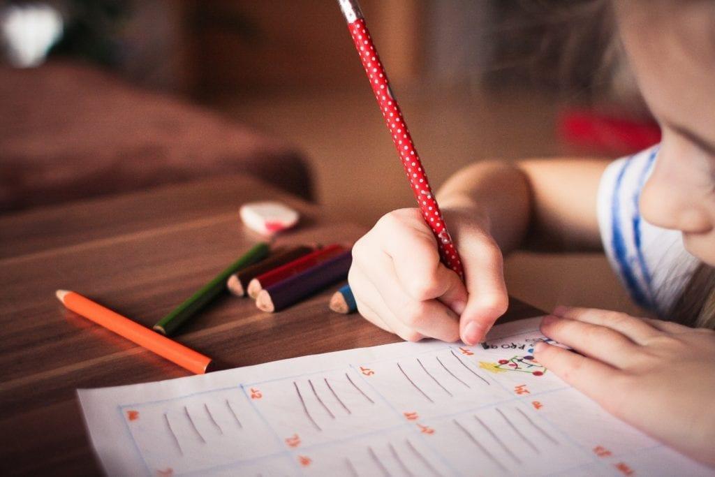 Blurred child working on homework in home