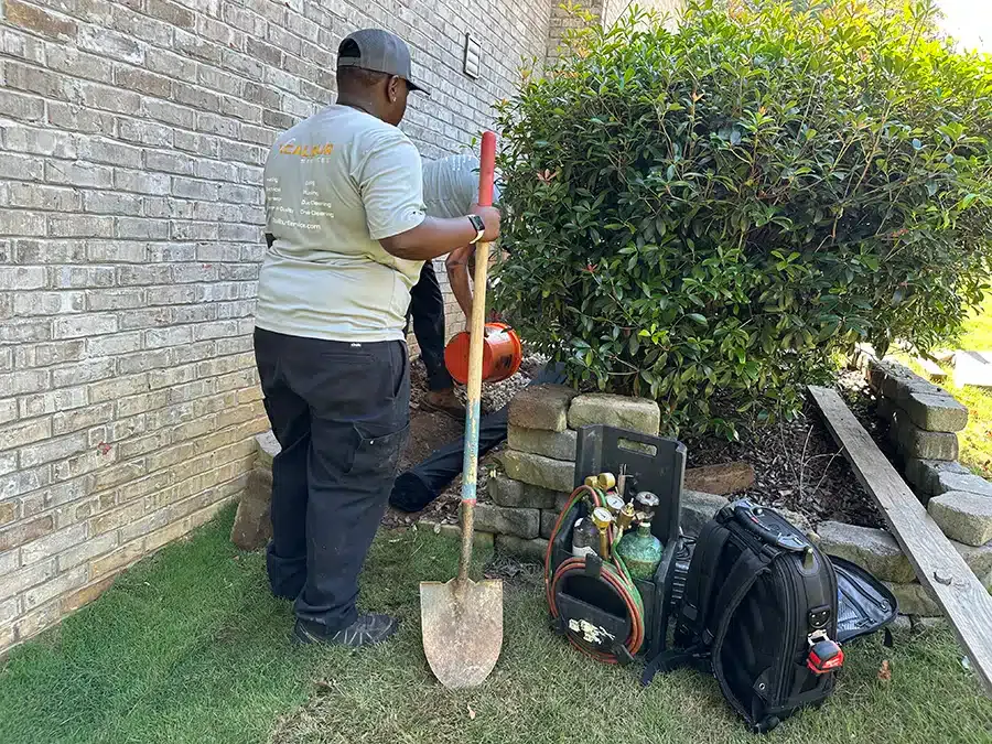 Xcalibur Services technicians conducting AC installation outside of home in Birmingham, AL